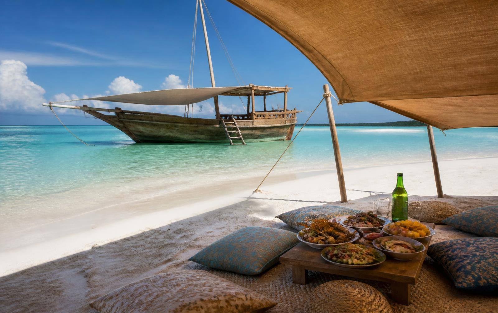 Dhow anchored at a sandbank with a shaded picnic set up in Zanzibar