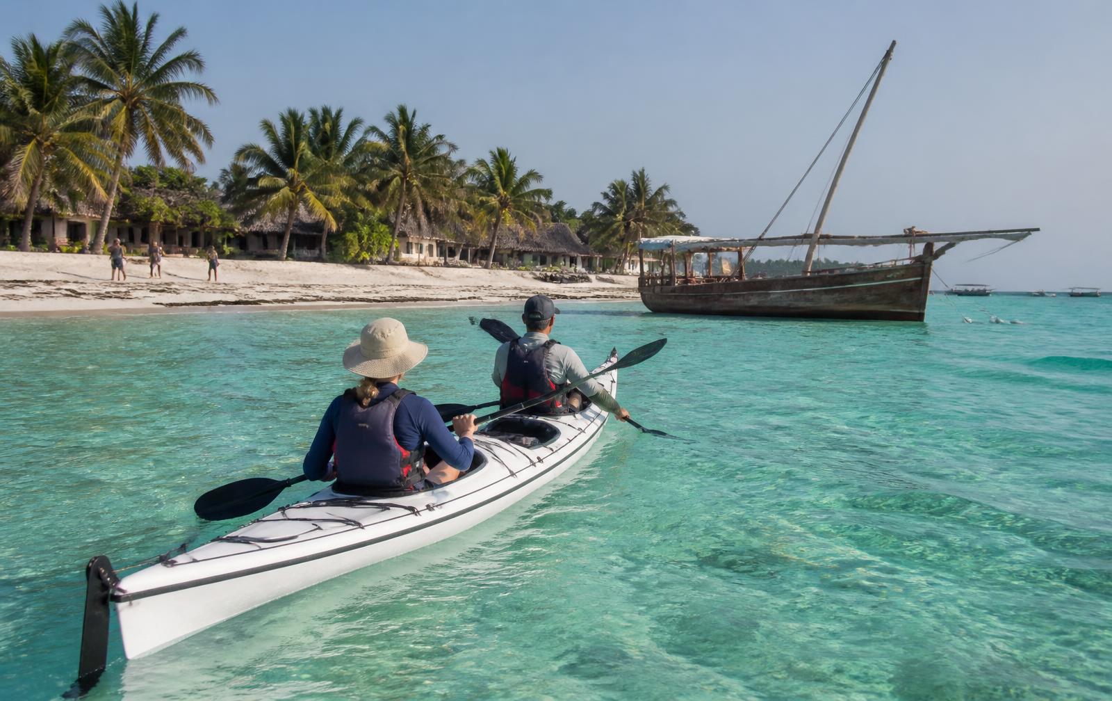 Sea kayak on clear turquoise water near a Zanzibar village beach