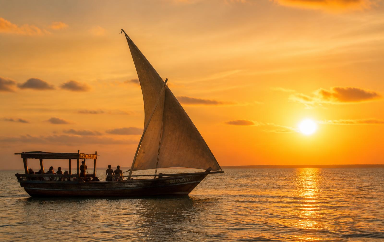 Traditional dhow sailing at sunset off the Zanzibar coast