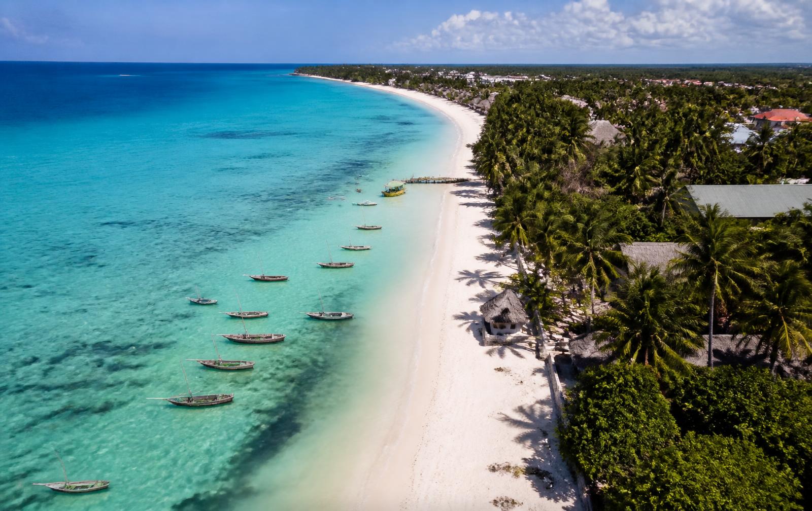 Aerial view of the Zanzibar coastline with turquoise lagoon and fishing boats