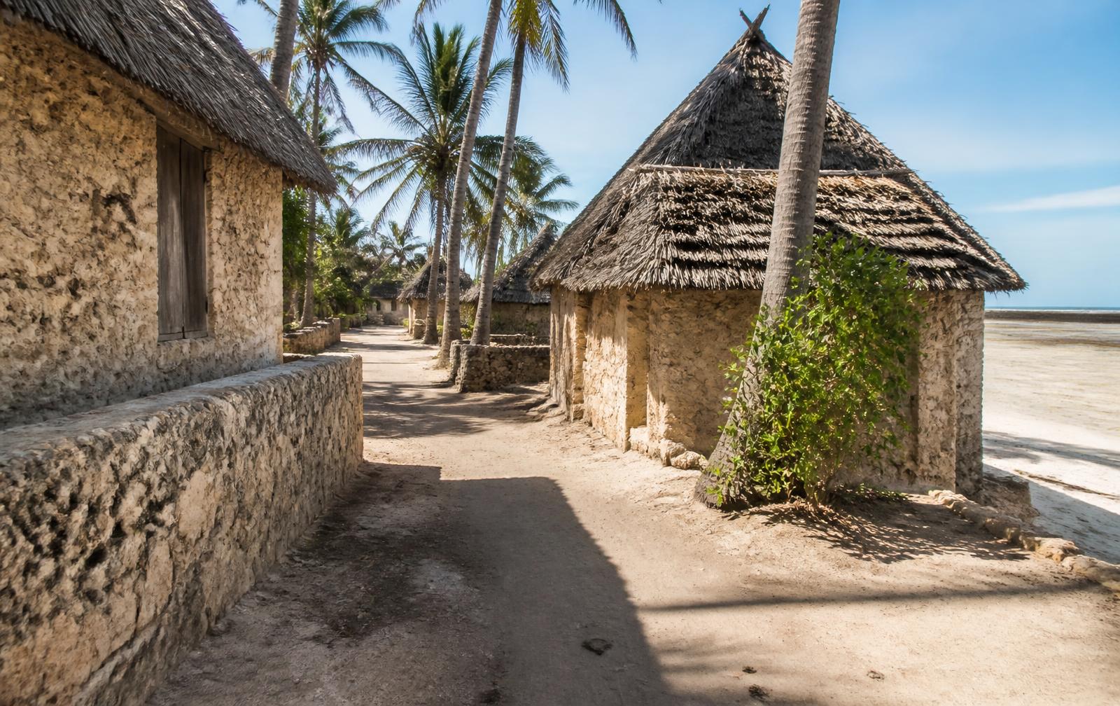 Coral stone houses and a sandy lane in Makunduchi village, southern Zanzibar