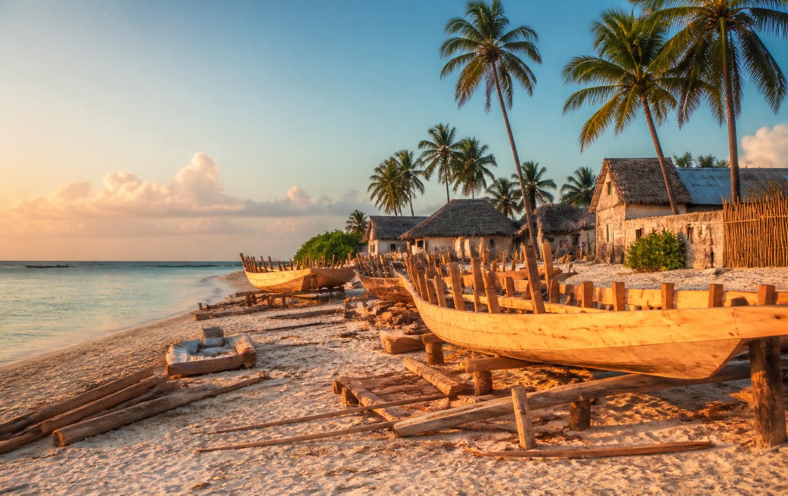 Wooden dhow boats being built on the white sand at Nungwi beach, Zanzibar